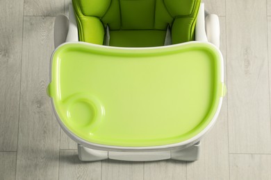 Photo of Green baby high chair indoors, top view
