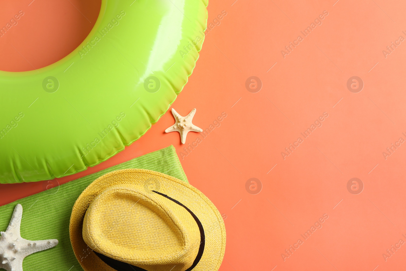 Photo of Flat lay composition with beach accessories on orange background, space for text