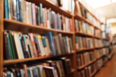 Photo of Blurred view of cabinets with books in library