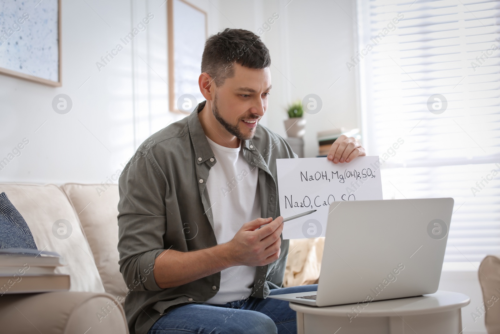 Photo of Teacher conducting online lesson at home during COVID-19 quarantine