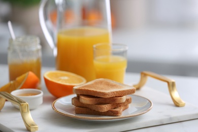 Tasty breakfast with toasted bread on tray in kitchen