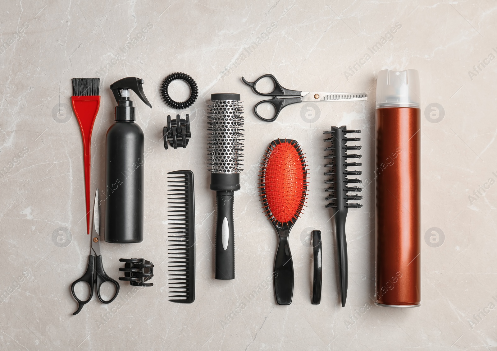 Photo of Flat lay composition with professional hairdresser tools on grey background