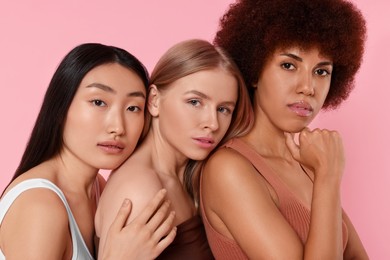 Portrait of beautiful young women on pink background