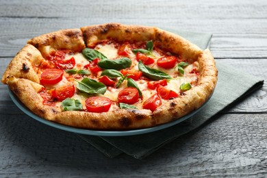 Photo of Delicious Margherita pizza on gray table, closeup