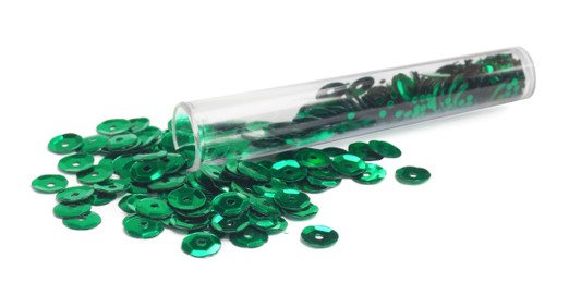 Photo of Many green sequins and tube on white background