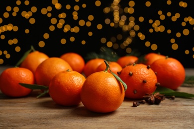 Fresh tangerines on wooden table, space for text. Christmas atmosphere