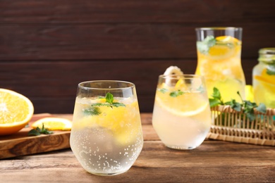 Photo of Delicious refreshing citrus drink on wooden table