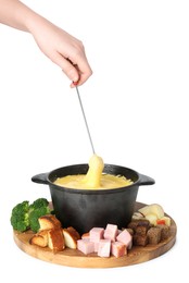Photo of Woman dipping piece of ham into fondue pot with tasty melted cheese on white background, closeup