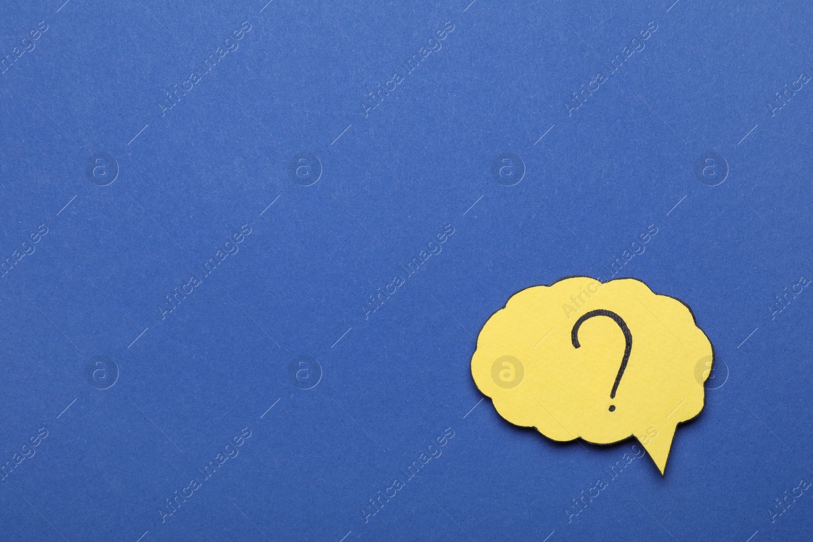 Photo of Paper speech bubble with question mark on blue background, top view. Space for text