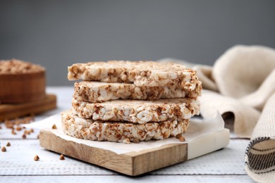 Photo of Stack of crunchy buckwheat cakes on white wooden table