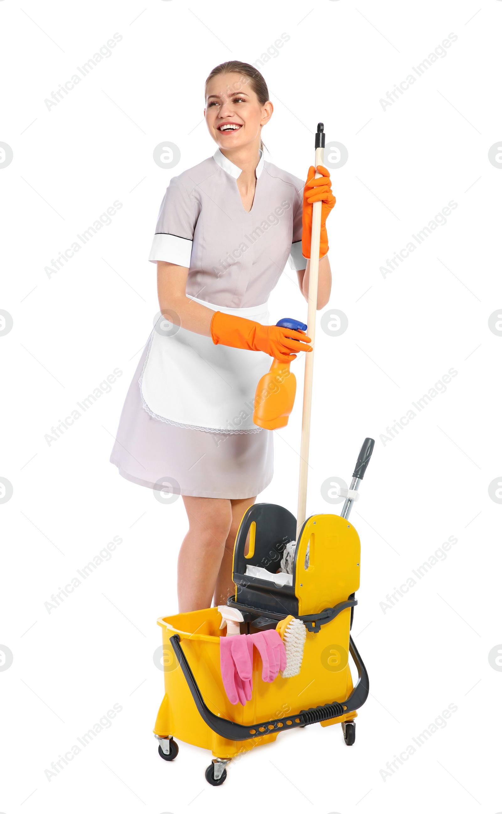 Photo of Young chambermaid with cleaning supplies on white background