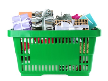 Green shopping basket with different gifts on white background