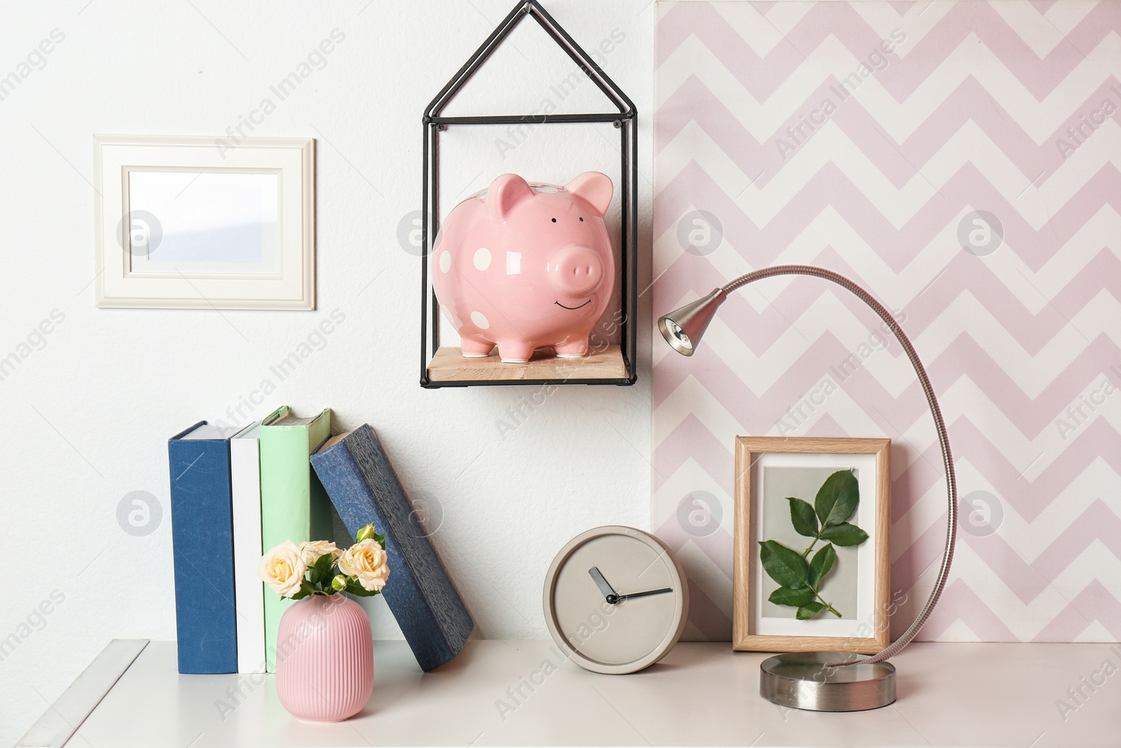 Photo of Cute piggy bank on shelf indoors. Stylish interior element