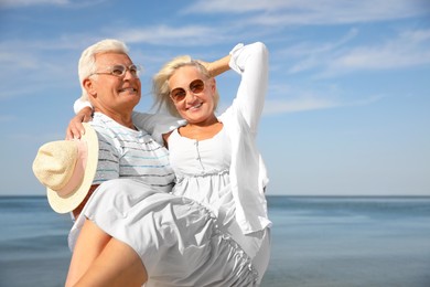 Photo of Mature couple spending time together near sea