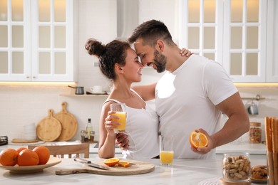 Photo of Lovely couple enjoying time together during breakfast at table in kitchen