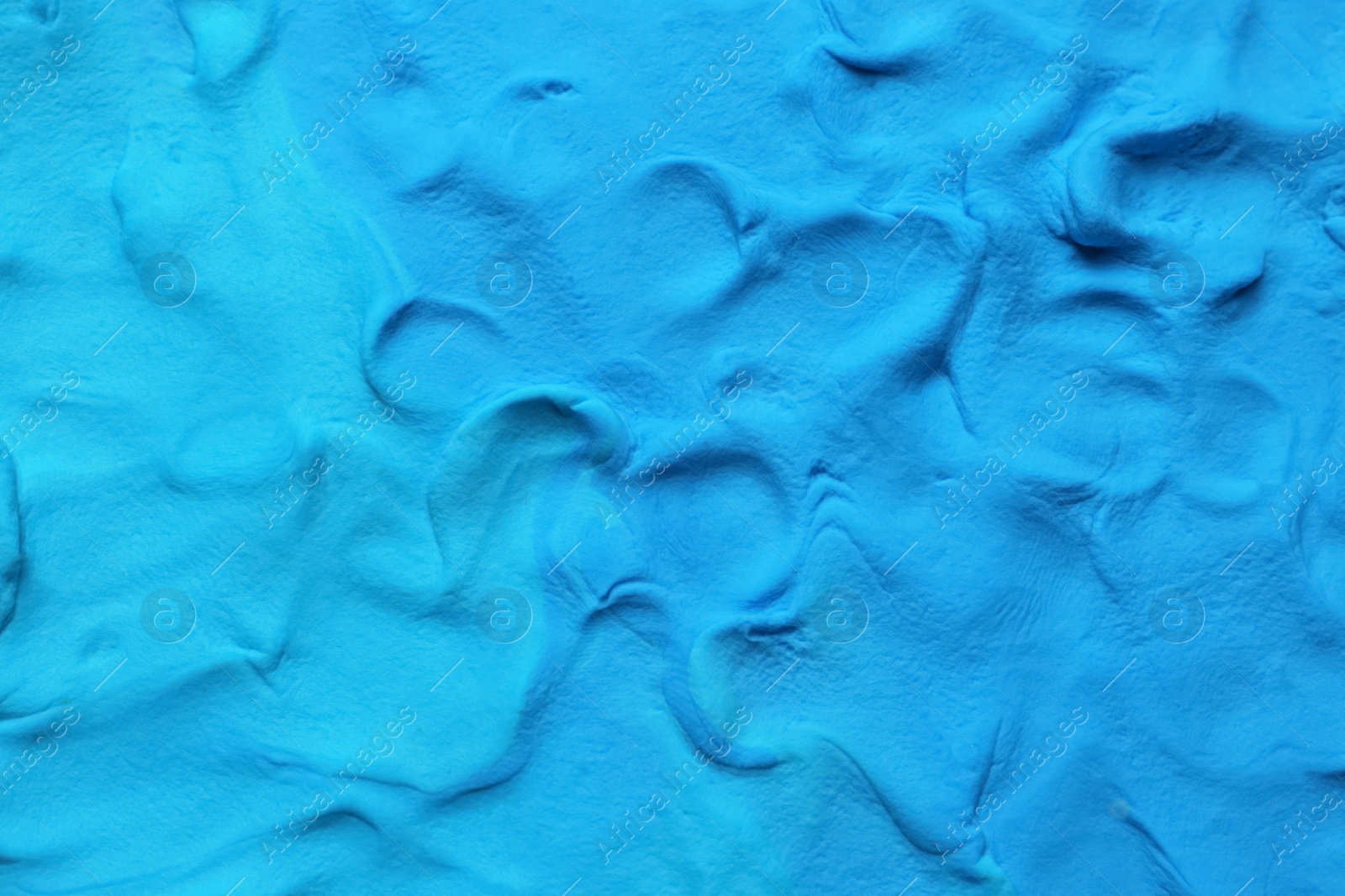 Photo of Light blue play dough as background, top view