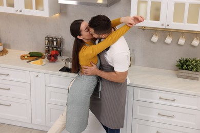 Lovely couple enjoying time together in kitchen