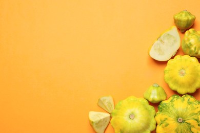 Fresh ripe pattypan squashes on orange background, flat lay. Space for text