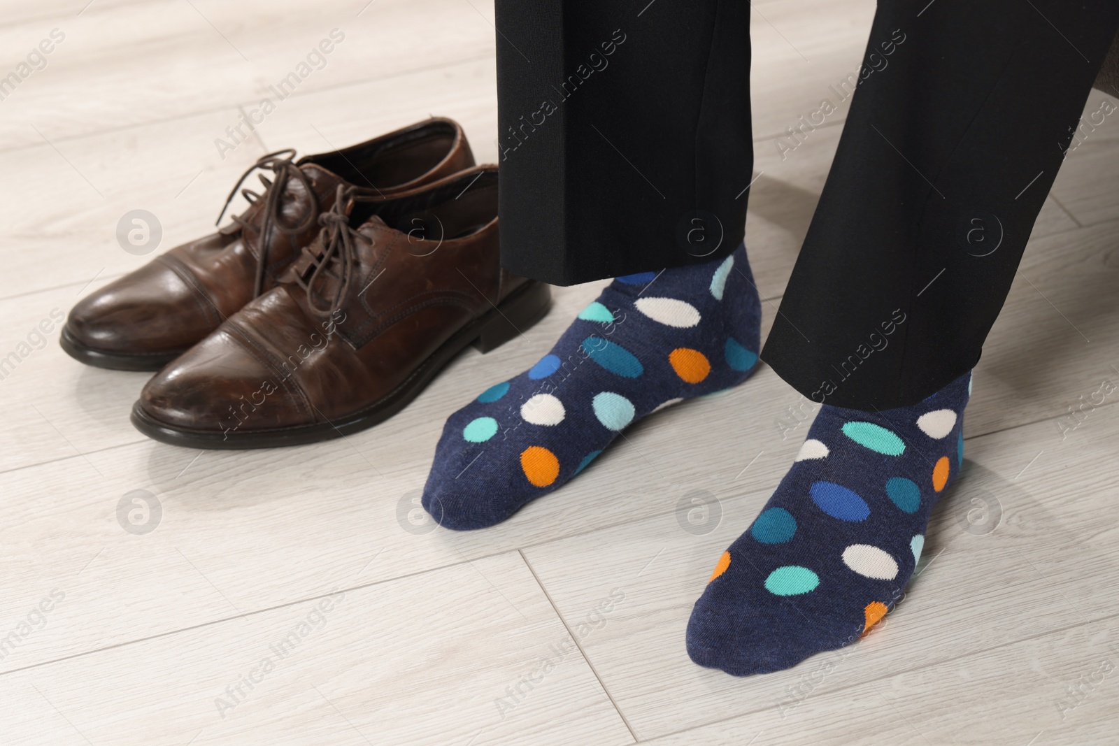 Photo of Man wearing colorful socks indoors, closeup view