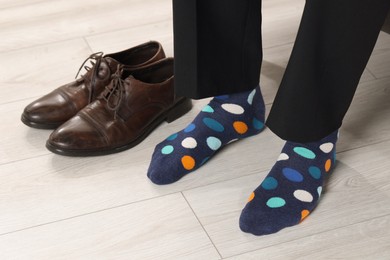 Man wearing colorful socks indoors, closeup view