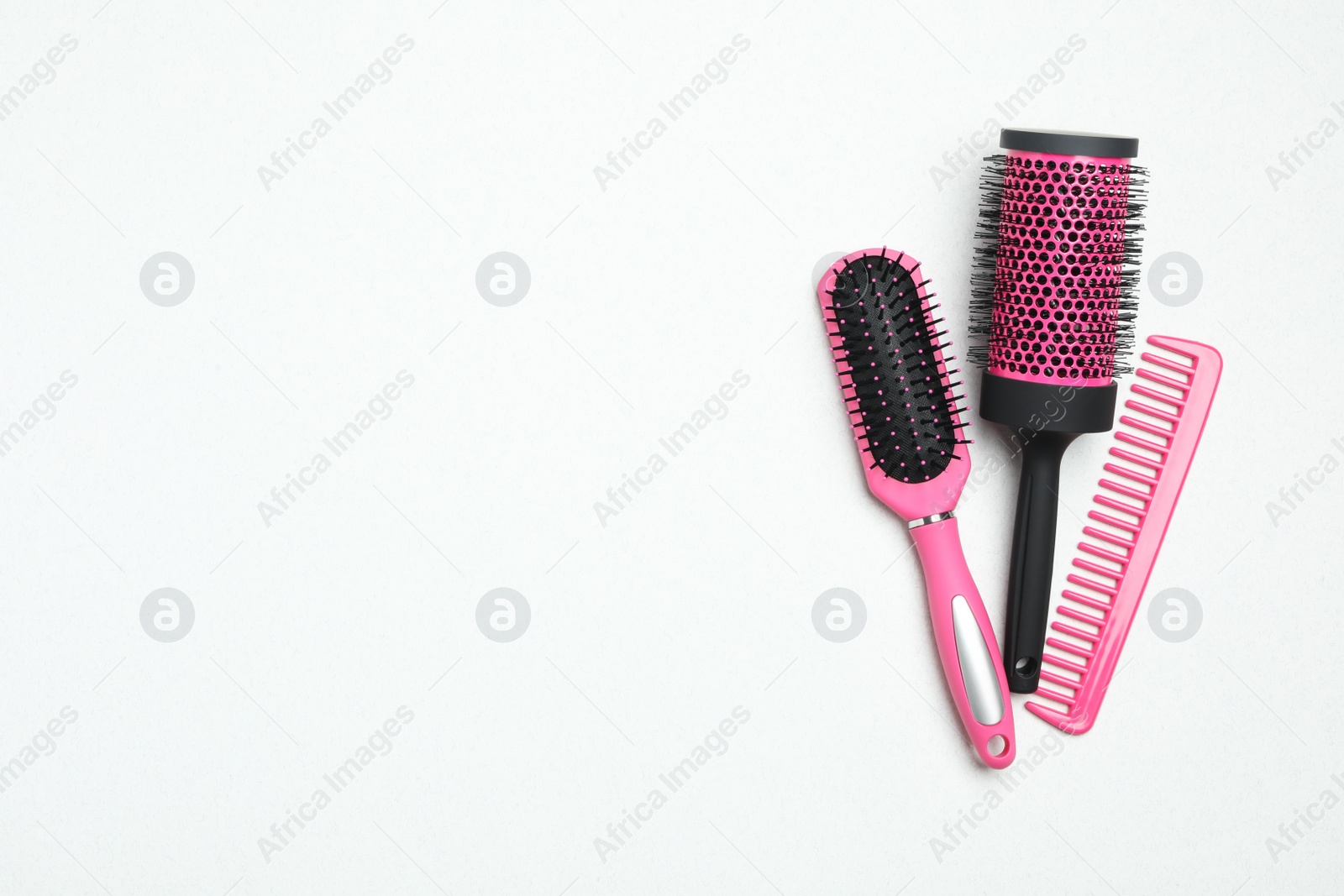 Photo of Modern hair comb and brushes on white background, flat lay. Space for text