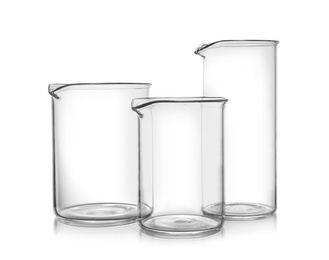 Clean empty glass beakers on white background