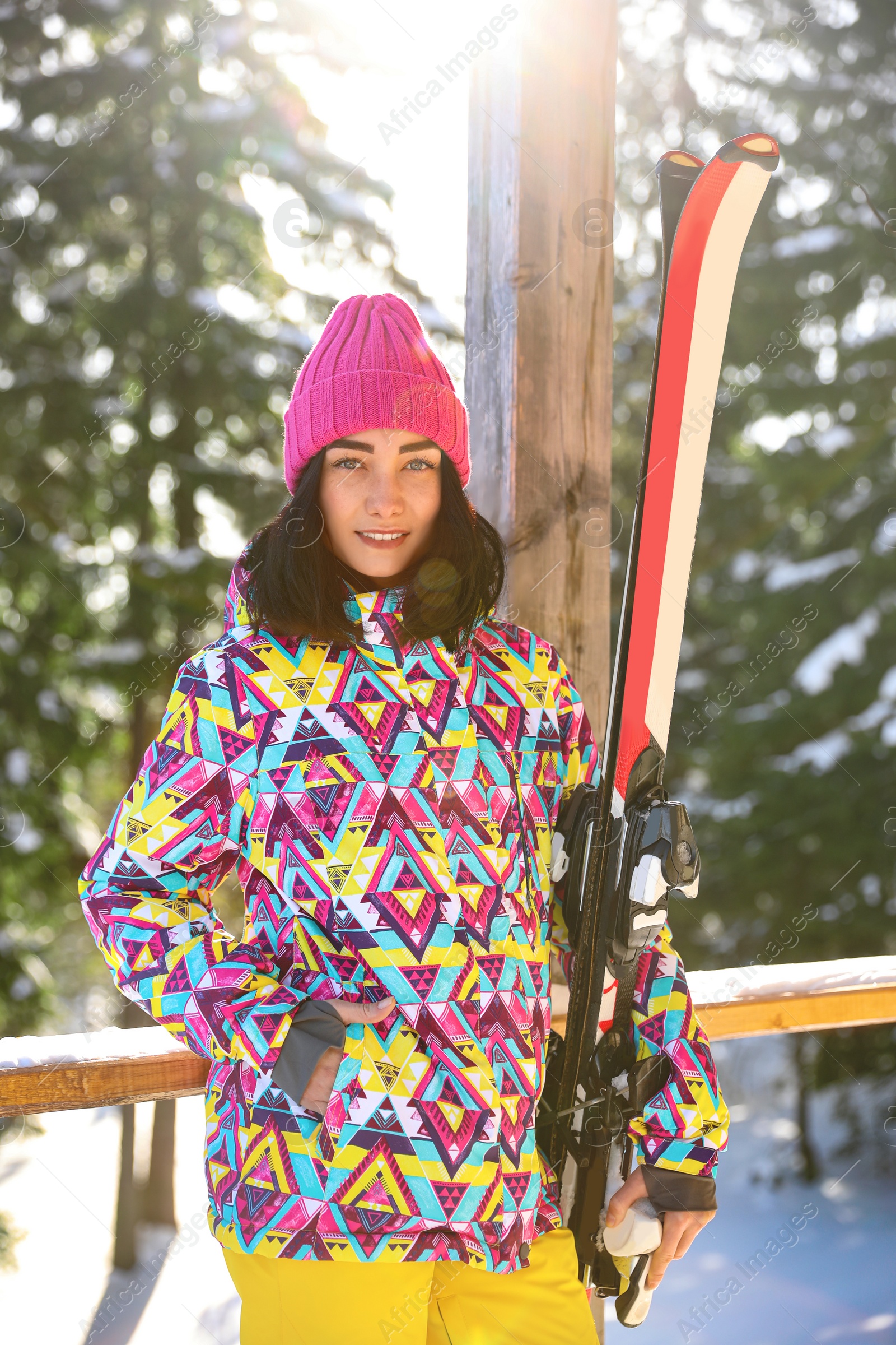 Photo of Young woman with ski wearing winter sport clothes in forest