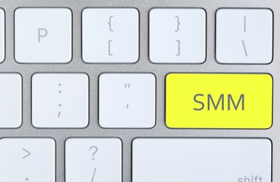 Image of Yellow button with word SMM on computed keyboard, top view