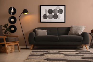 Photo of Stylish living room interior with comfortable dark sofa