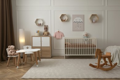 Modern baby room interior with stylish furniture and toys