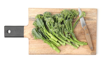 Wooden board with fresh raw broccolini and knife isolated on white, top view. Healthy food