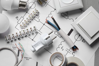 Photo of Flat lay composition with electrician's accessories on grey background