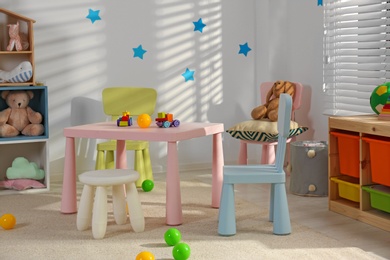 Photo of Cozy baby room interior with stylish furniture