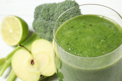 Photo of Delicious fresh green juice in glass, closeup. Space for text