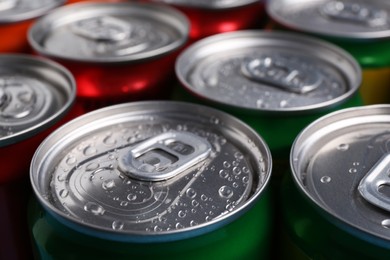 Photo of Energy drinks in wet cans, closeup. Functional beverage