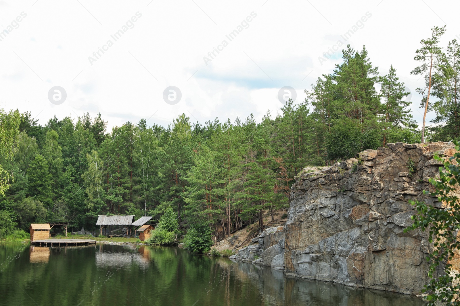 Photo of Beautiful landscape with forest and rocky mountain near lake. Camping season