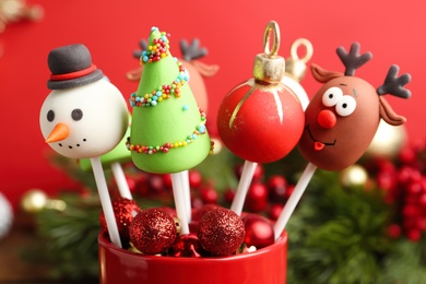 Delicious Christmas themed cake pops on blurred  background, closeup