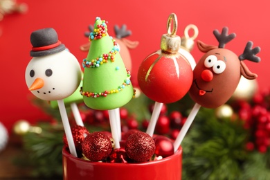 Photo of Delicious Christmas themed cake pops on blurred  background, closeup