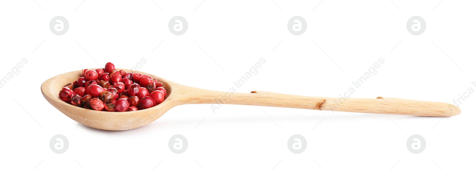 Photo of Spoon of red peppercorns isolated on white