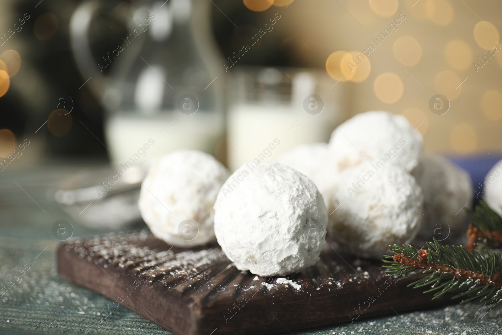 Photo of Tasty Christmas snowball cookies on table, closeup. Space for text