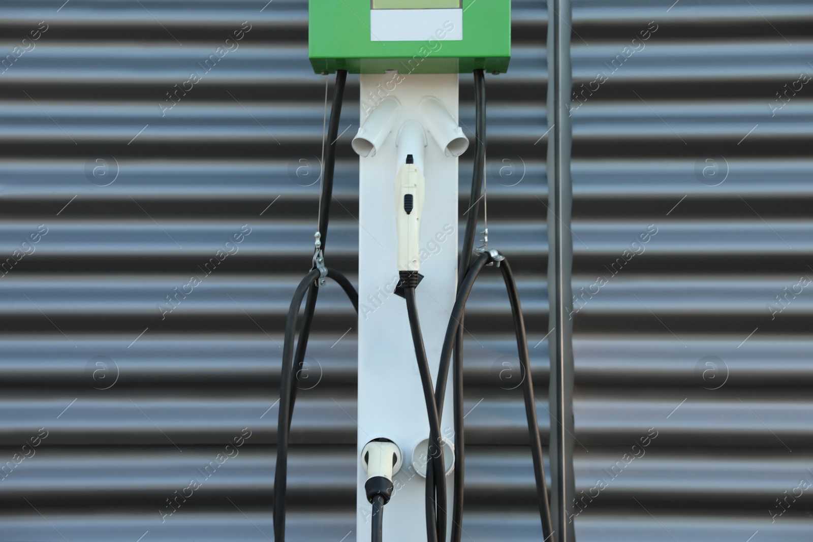 Photo of Electric vehicle charging station outdoors. Modern technology
