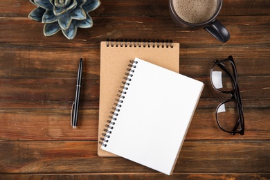 Photo of Flat lay composition with office stationery on wooden table. Space for design