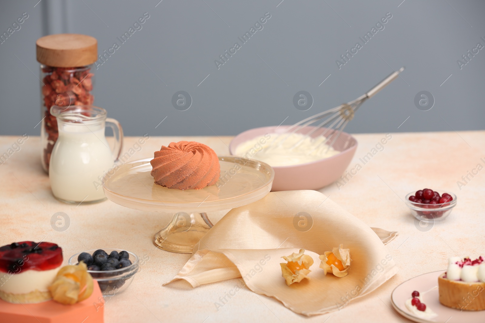 Photo of Beautiful composition of delicious desserts on beige table indoors. Food stylist