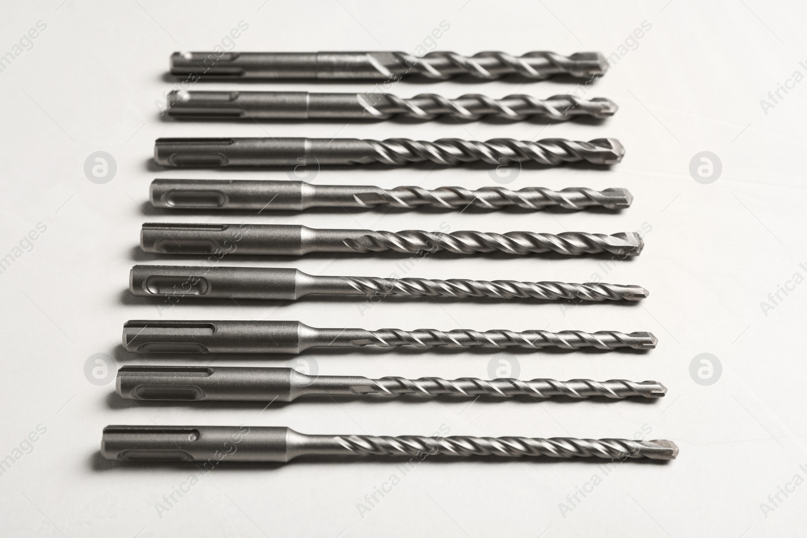 Photo of Many different drill bits on white table