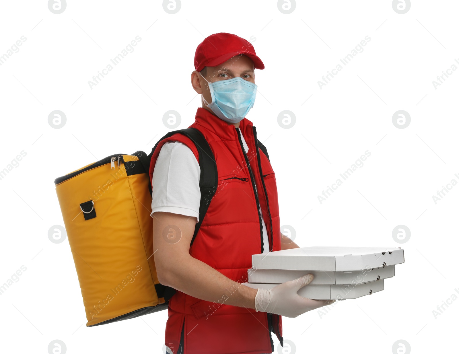 Photo of Courier in protective mask and gloves holding pizza boxes on white background. Food delivery service during coronavirus quarantine