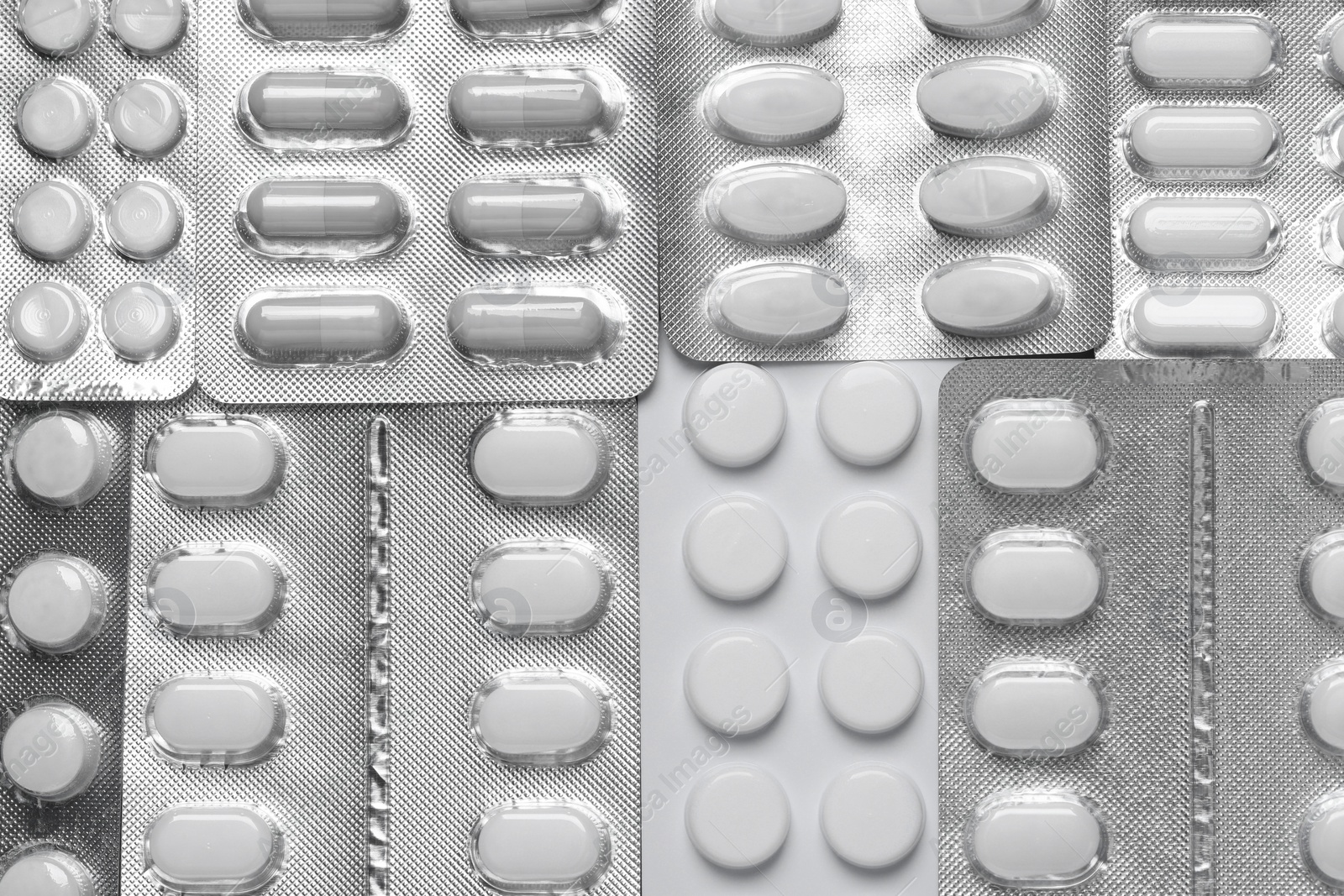 Photo of Many different pills in blisters as background, top view