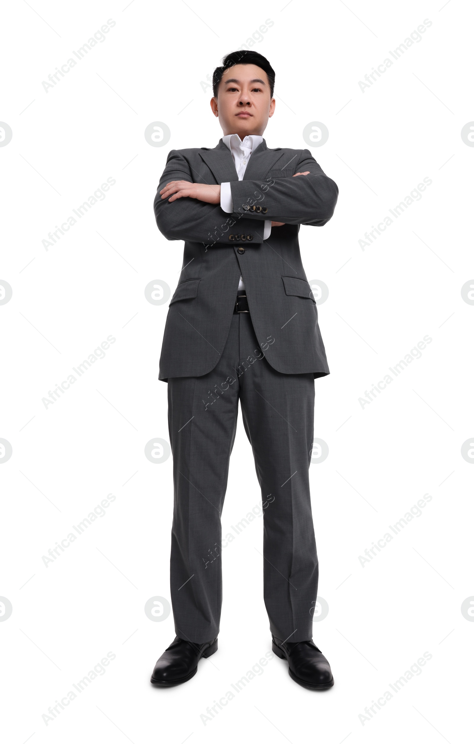 Photo of Businessman in suit posing on white background, low angle view