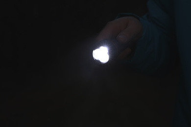 Photo of Man with bright flashlight at night, closeup