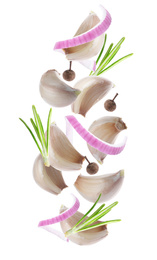 Image of Set of falling garlic cloves and other seasonings on white background