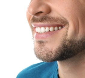 Photo of Smiling man with perfect teeth on white background, closeup